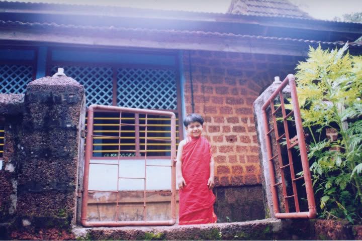 A child in traditional dress at a village temple in Kudal